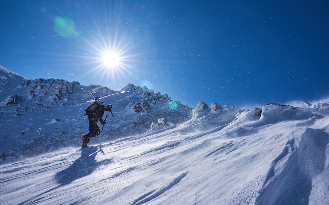 a man riding skis down a snow covered slope