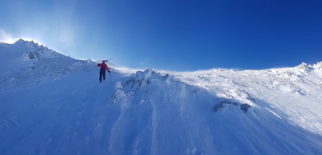 a person standing on top of a snow covered mountain